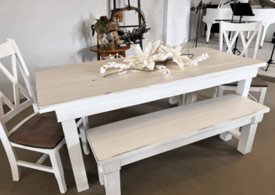 Custom white painted table with benches. Painted chairs are custom made with stained bottoms